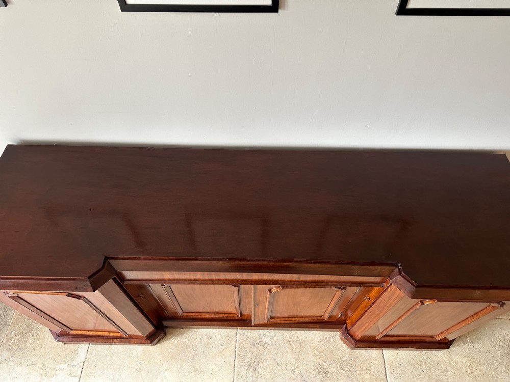 A nineteenth-century Victorian mahogany breakfront sideboard featuring four moulded panel doors and a polished wooden top. View VII