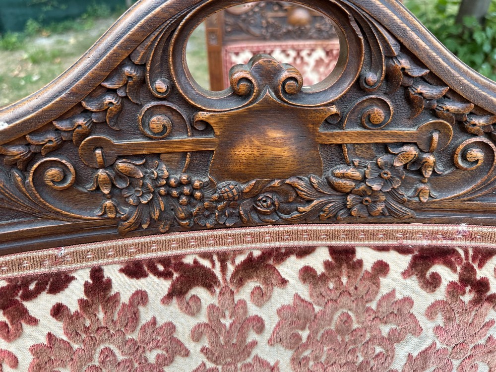 A set of ten Edwardian oak dining chairs featuring carved top rails, turned legs, and burgundy patterned velvet upholstery. View VI