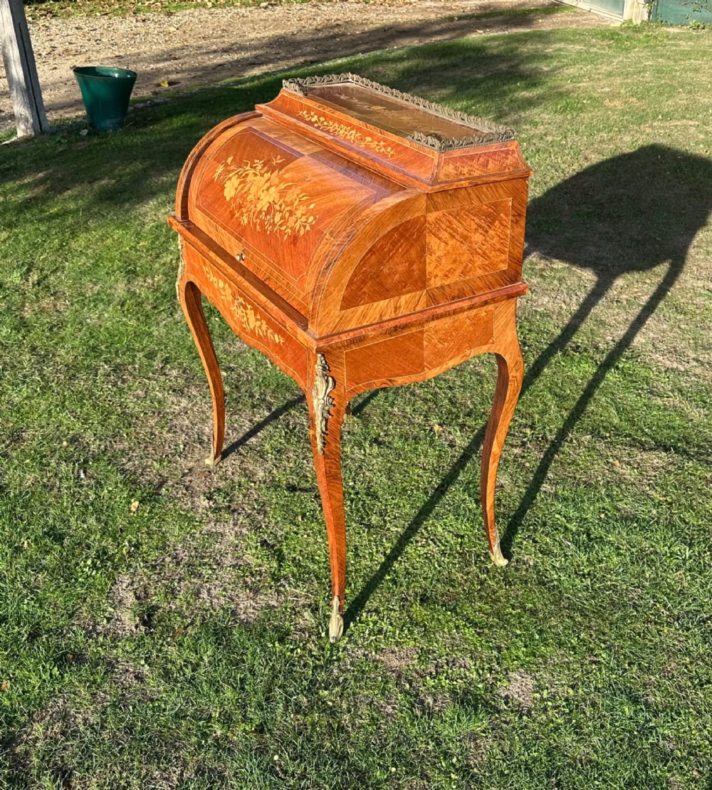 A 19th-century French cylinder roll-top desk crafted with floral marquetry inlays, slender cabriole legs, and brass ormolu mounts. View II