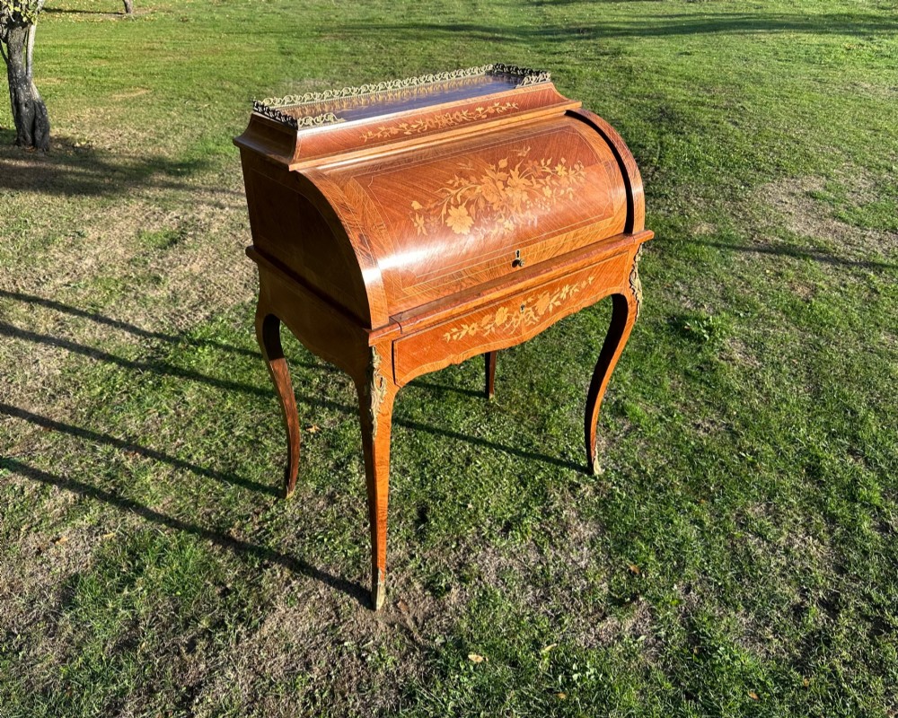 A 19th-century French cylinder roll-top desk crafted with floral marquetry inlays, slender cabriole legs, and brass ormolu mounts. View III