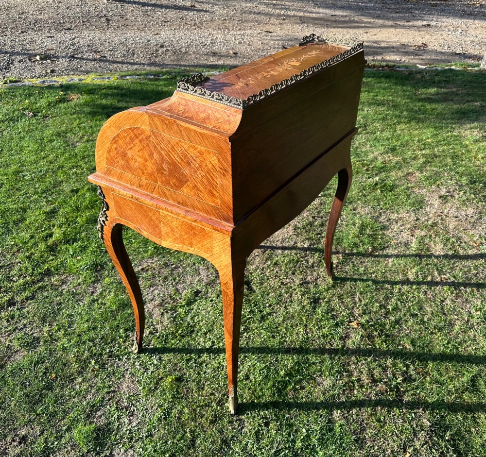 A 19th-century French cylinder roll-top desk crafted with floral marquetry inlays, slender cabriole legs, and brass ormolu mounts. View VIII