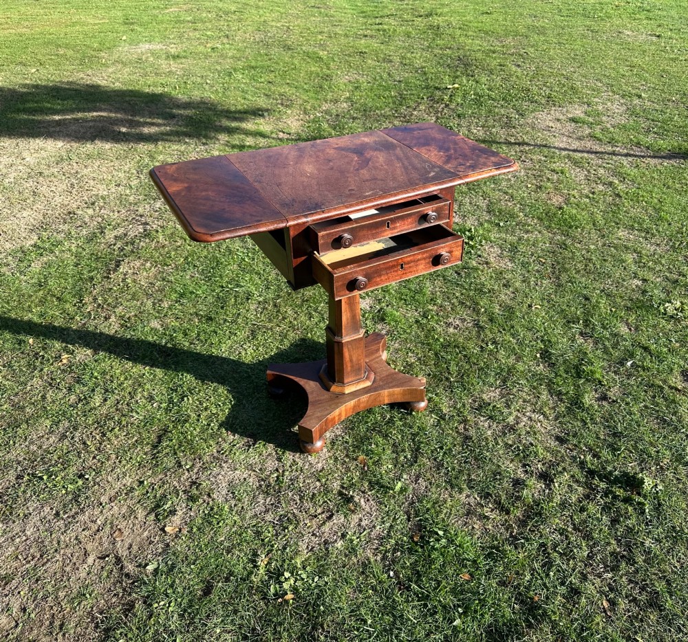 A 19th-century mahogany Pembroke table featuring two drawers, two folding drop leaves, a central pedestal column, and a shaped quadform base. View III