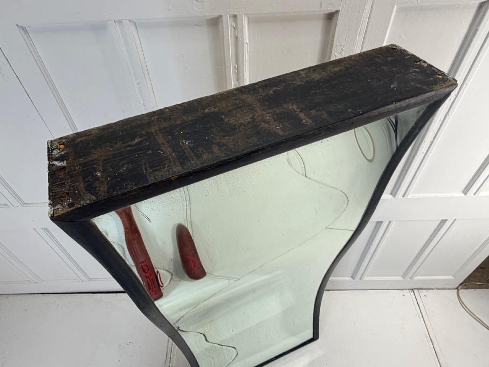 A tall, rectangular 19th-century fairground distortion mirror with curved glass housed inside a simple dark painted wooden frame. View IX