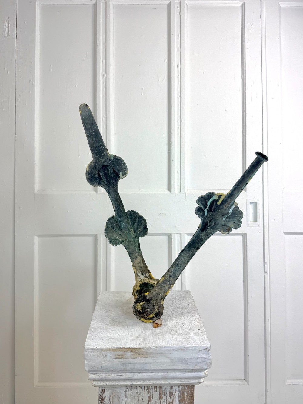 A pair of large Georgian copper clock hands displaying distressed yellow painted surfaces and dark oxidised metal. View III