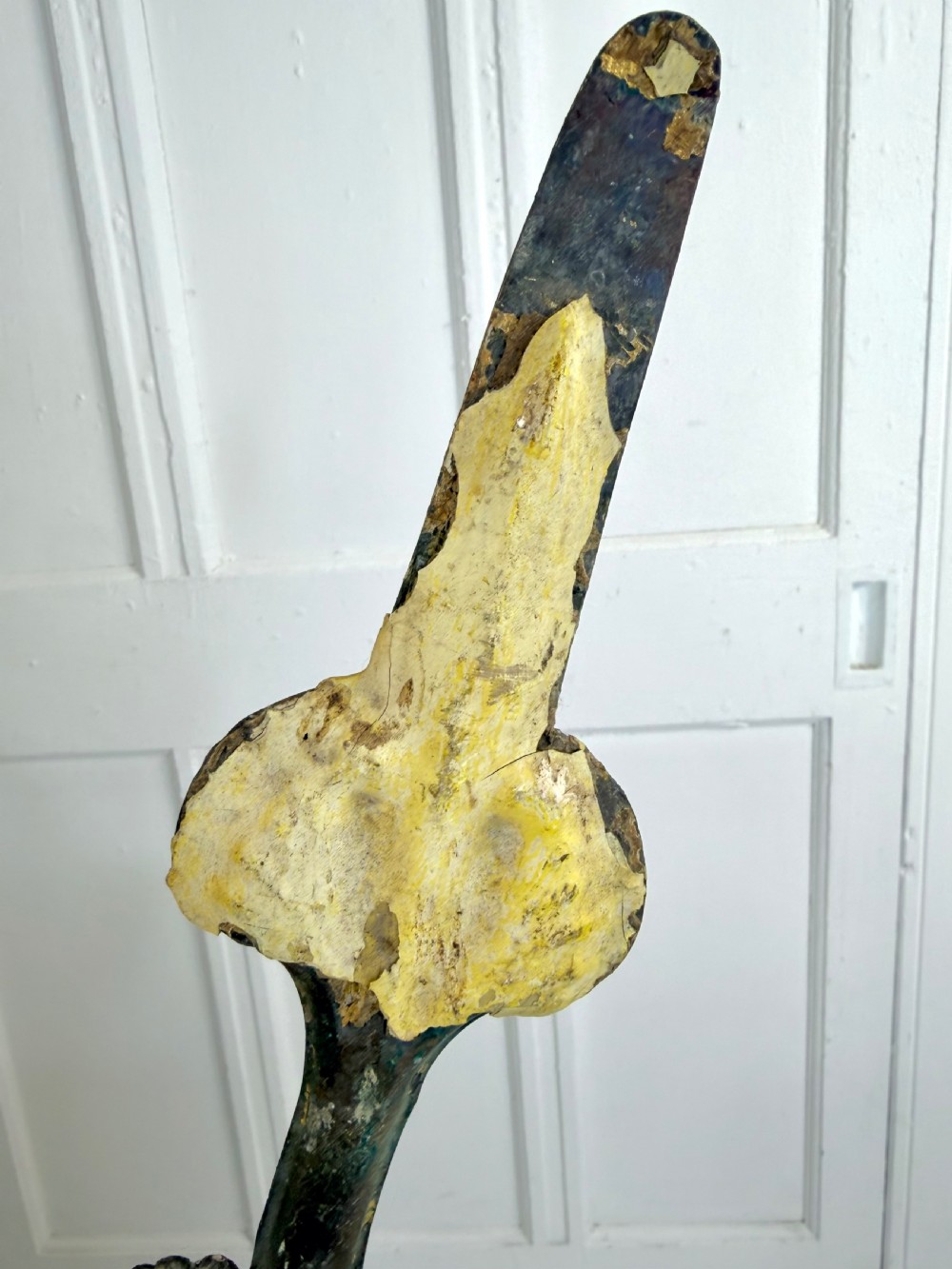 A pair of large Georgian copper clock hands displaying distressed yellow painted surfaces and dark oxidised metal. View IV