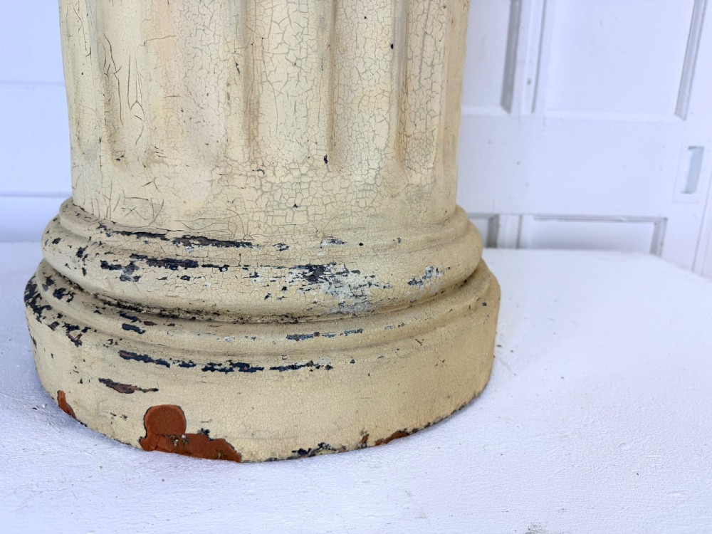 A nineteenth-century fluted terracotta display column with a distressed cream painted finish and a circular capital and base. View III