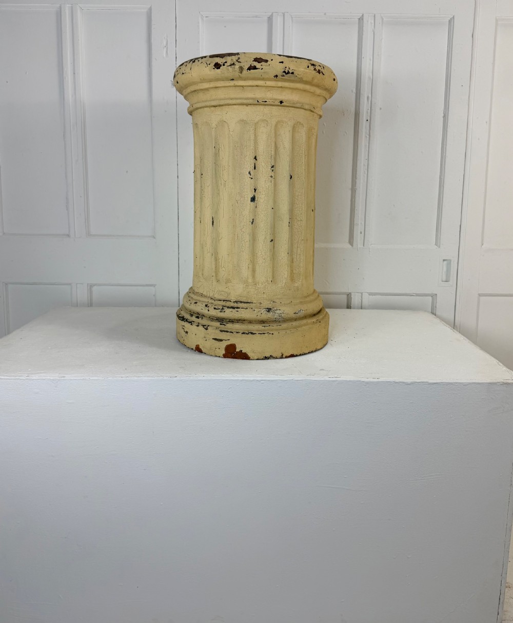 A nineteenth-century fluted terracotta display column with a distressed cream painted finish and a circular capital and base. View IV