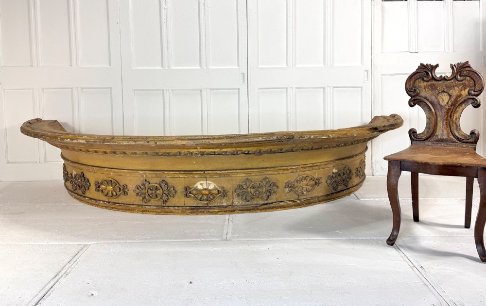 A large curved 19th-century carved timber and gilded window pelmet decorated with floral rosettes and egg-and-dart moulding. View IV