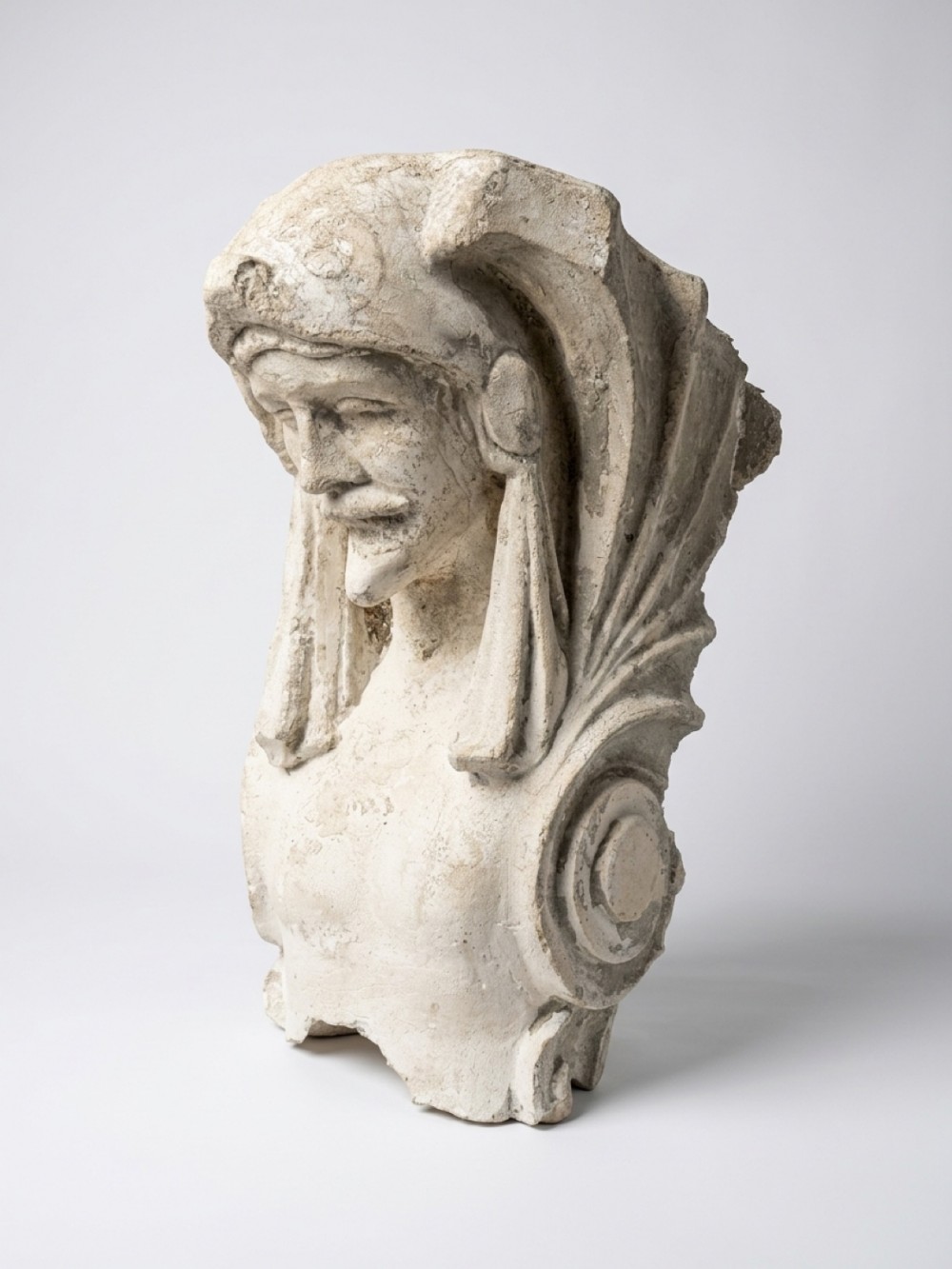 An off-white 19th-century plaster architectural fragment depicting a crowned male figure with a moustache and scrollwork details.