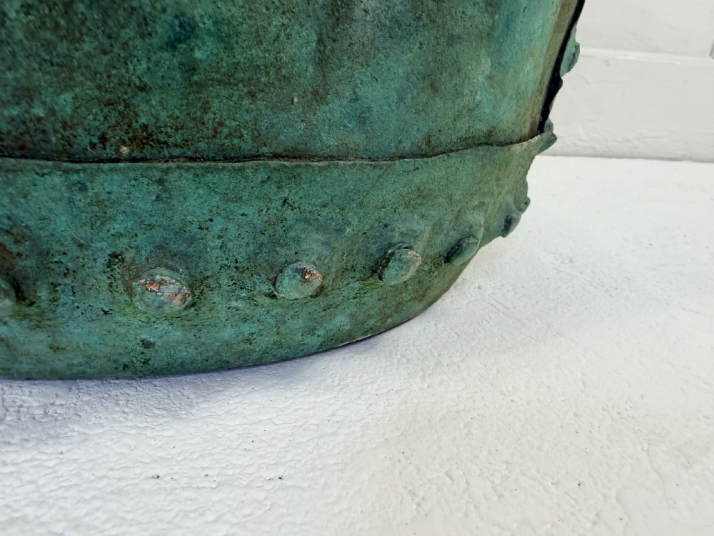 A 19th-century riveted copper garden planter pot featuring a heavily weathered verdigris patina and a perforated lower band. View II