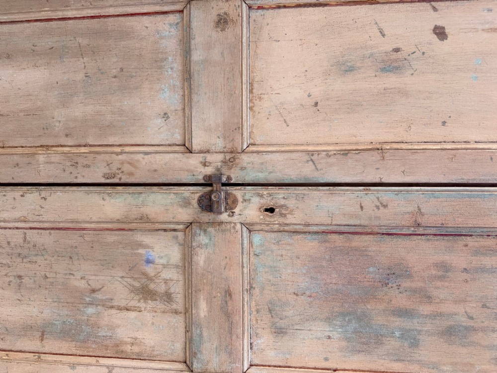 A tall 19th-century French pine housekeepers cupboard featuring two panelled tall doors with a central iron latch and a distressed natural wood finish. View V