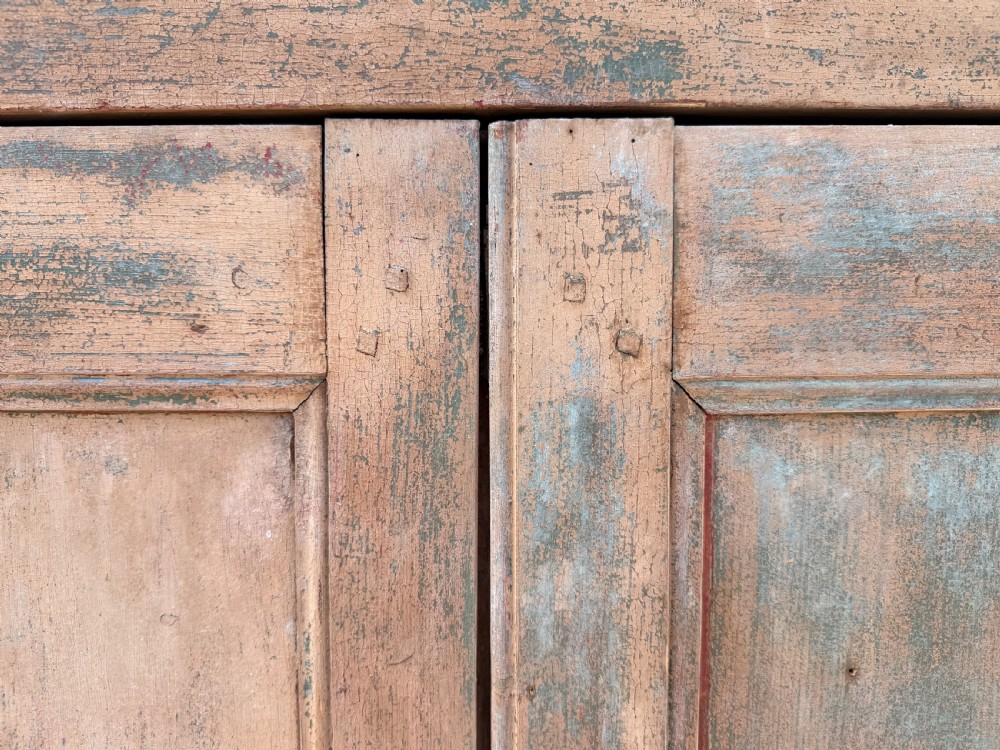 A tall 19th-century French pine housekeepers cupboard featuring two panelled tall doors with a central iron latch and a distressed natural wood finish. View VI