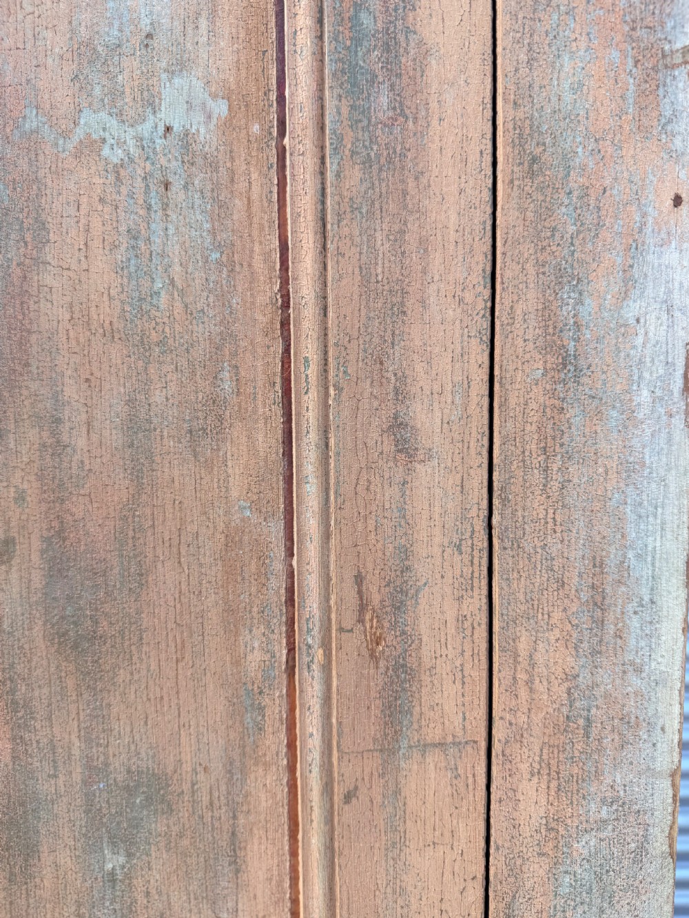 A tall 19th-century French pine housekeepers cupboard featuring two panelled tall doors with a central iron latch and a distressed natural wood finish. View VII