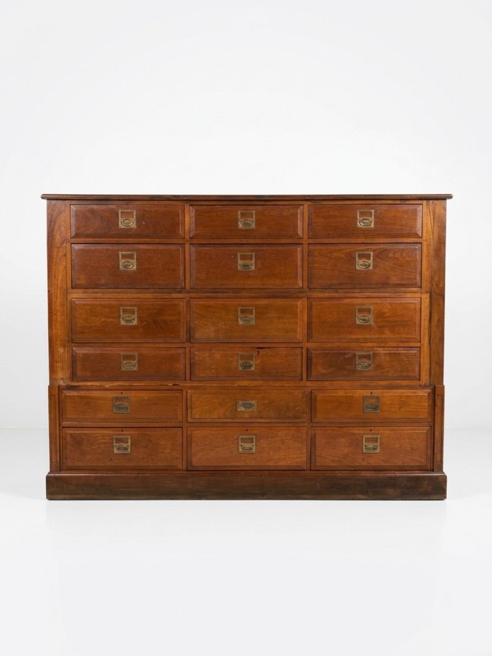 A large Victorian mahogany bank of eighteen drawers featuring brass handles with integrated label frames.