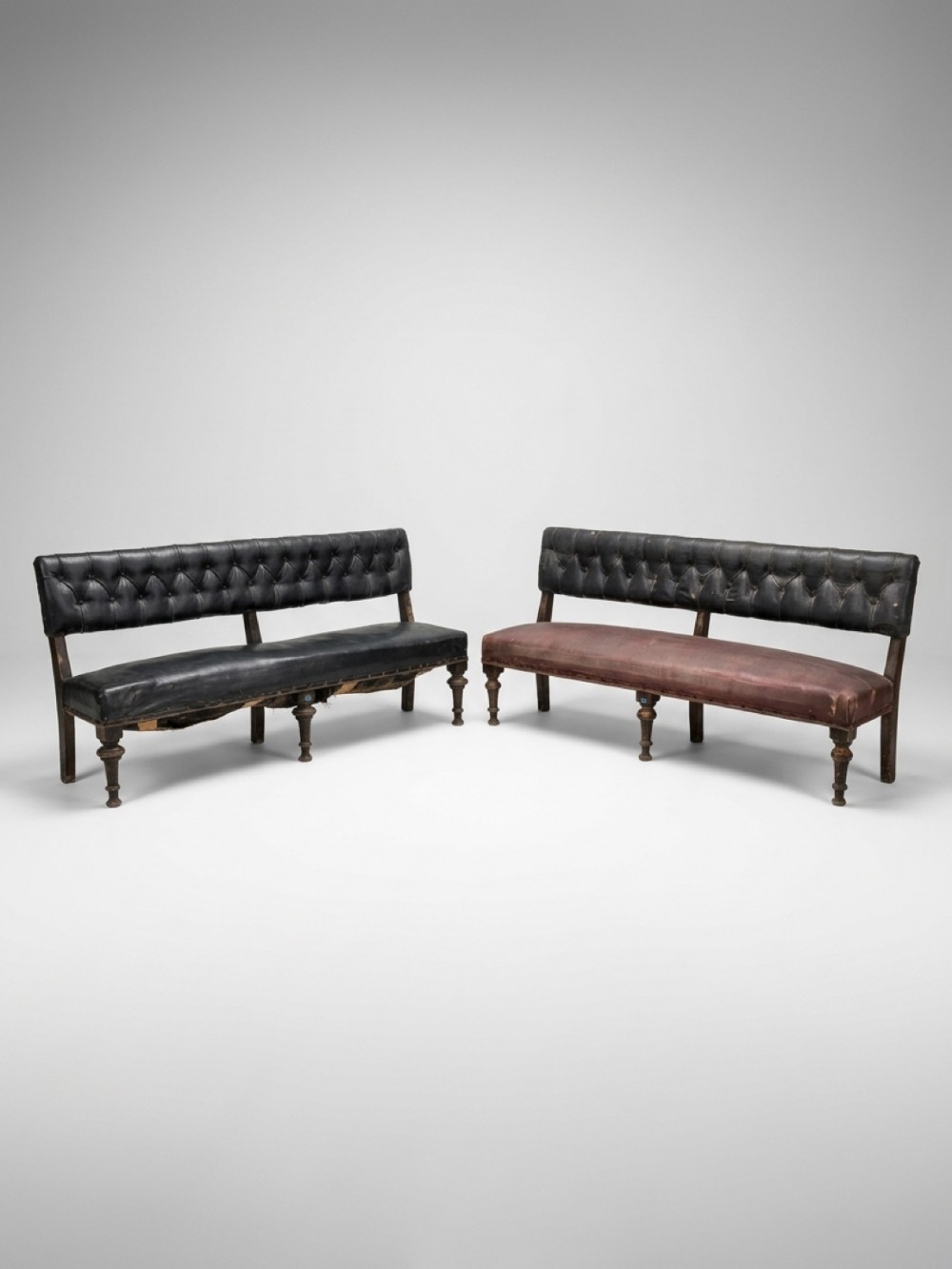 A pair of 19th-century Irish leather benches featuring button-backed upholstery and turned hardwood legs.