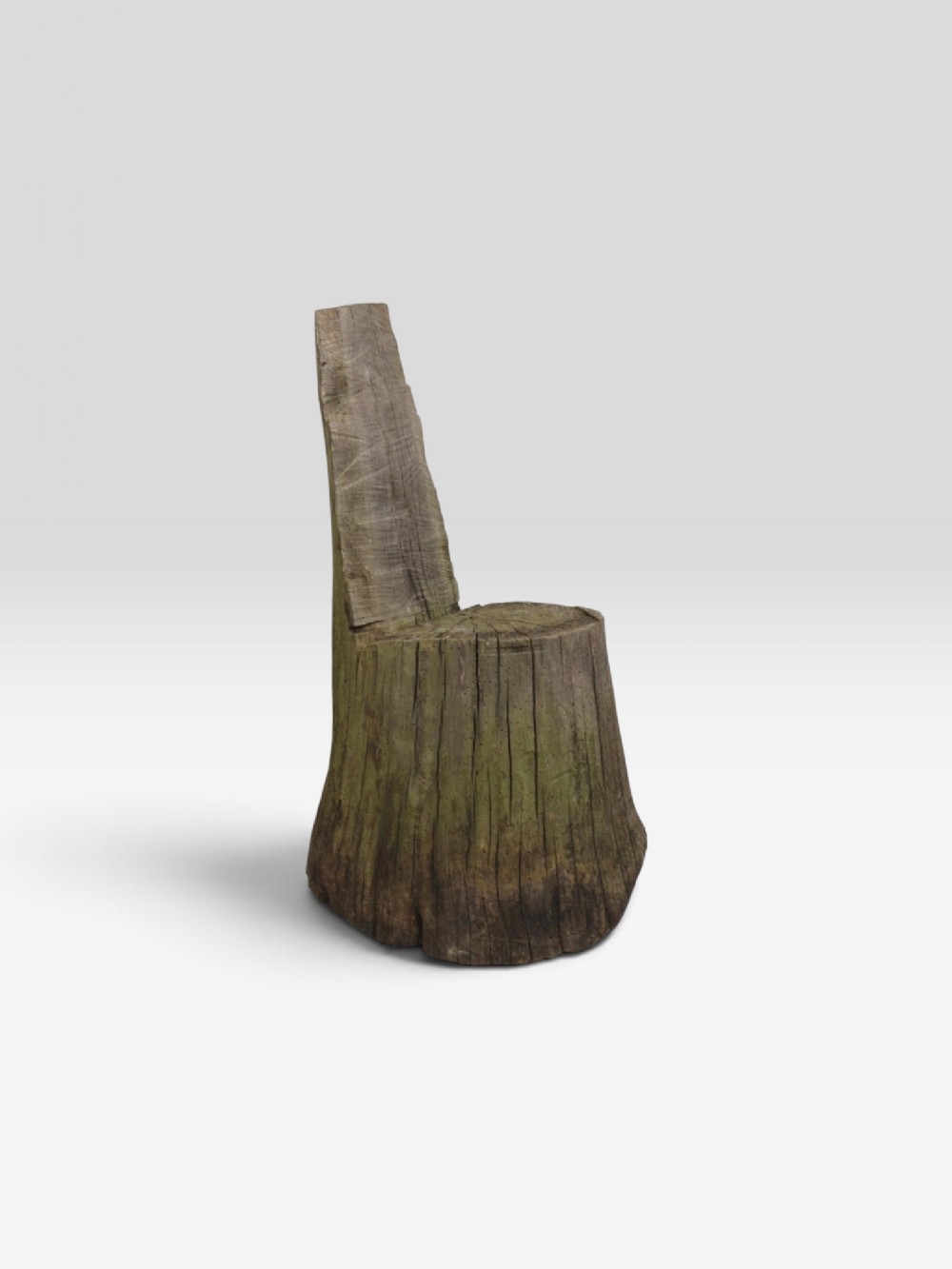 A rustic accent seat carved directly from a single weathered tree trunk with an integrated upright backrest.