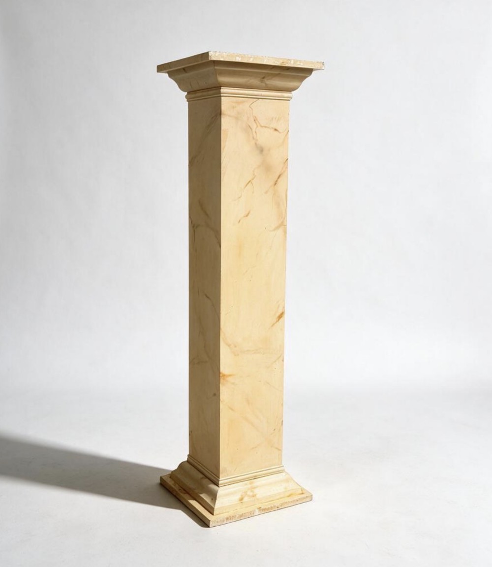A tall square wooden display column featuring a yellow and cream faux marble painted finish with a moulded capital and stepped base.