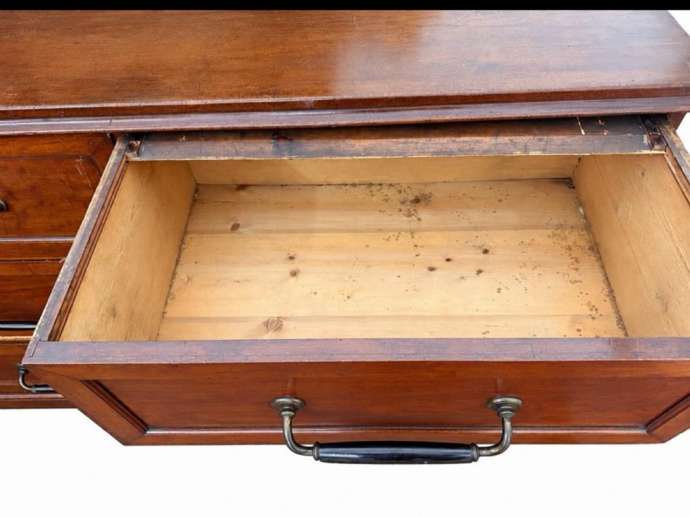 A large nineteenth-century wooden haberdashery unit featuring six drawers arranged in two columns with moulded drawer fronts and dark metal drop handles. View II
