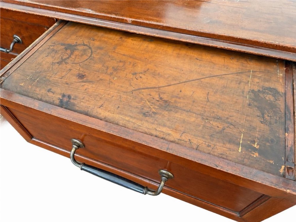 A large nineteenth-century wooden haberdashery unit featuring six drawers arranged in two columns with moulded drawer fronts and dark metal drop handles. View III