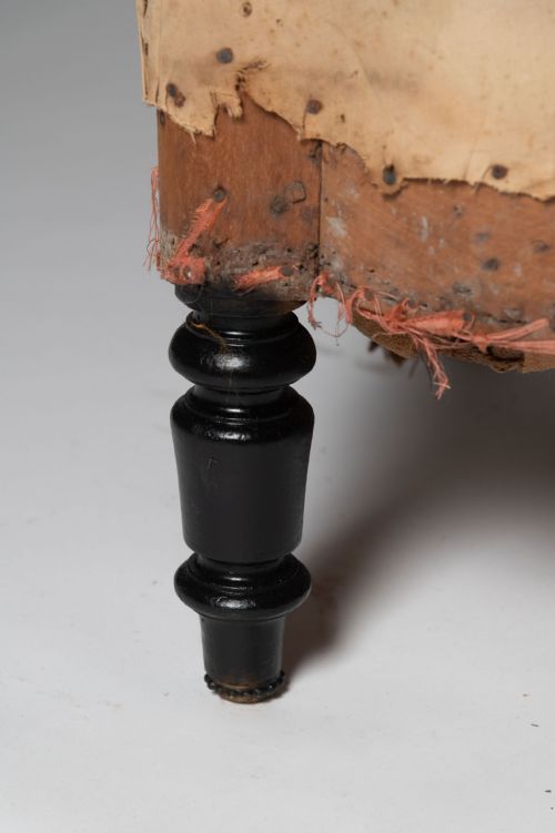 fig 1. An antique French marquise chair featuring extra wide seating, button-tufted calico lining, and turned ebonised front legs.