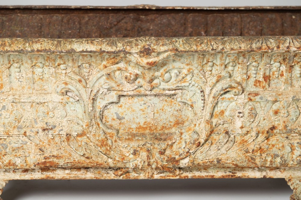 A 19th-century French rectangular cast iron planter featuring distressed off-white paint, detailed acanthus leaf relief, and short paw feet. View V