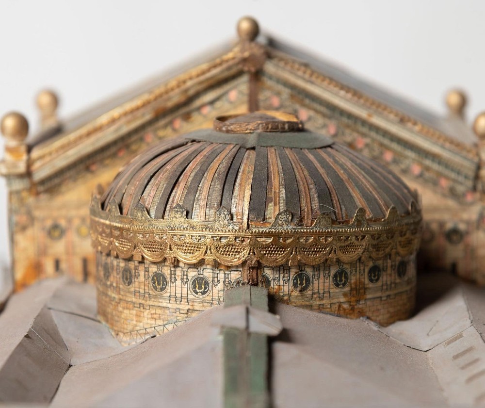 A detailed scale paper model of the Paris Opera House featuring a central dome, classical arcade facade, and miniature roof statuary mounted on a textured gravel base. View VI