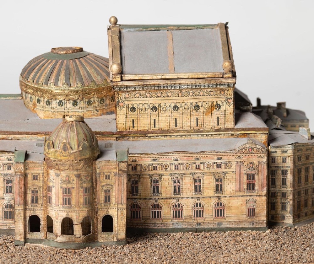 A detailed scale paper model of the Paris Opera House featuring a central dome, classical arcade facade, and miniature roof statuary mounted on a textured gravel base. View VIII