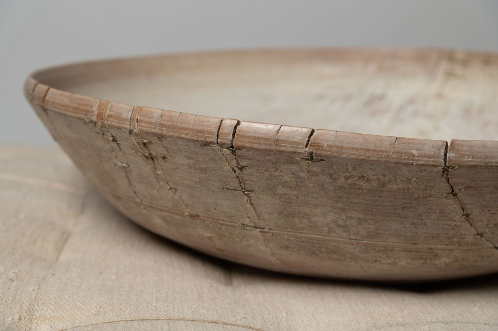 A wide, shallow antique Swedish wooden dairy bowl with a pale, scrubbed timber finish and subtle turned rim lines. View X