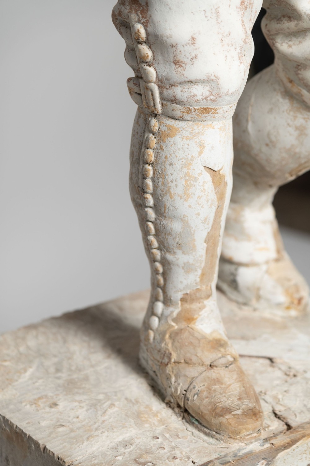 A standing antique hand-carved wooden statue of a nobleman in seventeenth-century attire with a distressed white painted finish. View VI