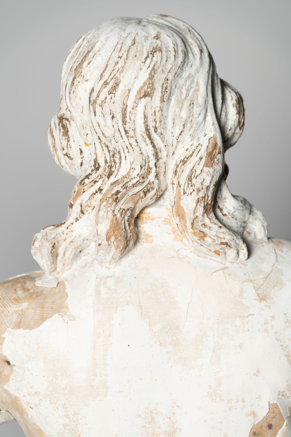 A standing antique hand-carved wooden statue of a nobleman in seventeenth-century attire with a distressed white painted finish. View VII