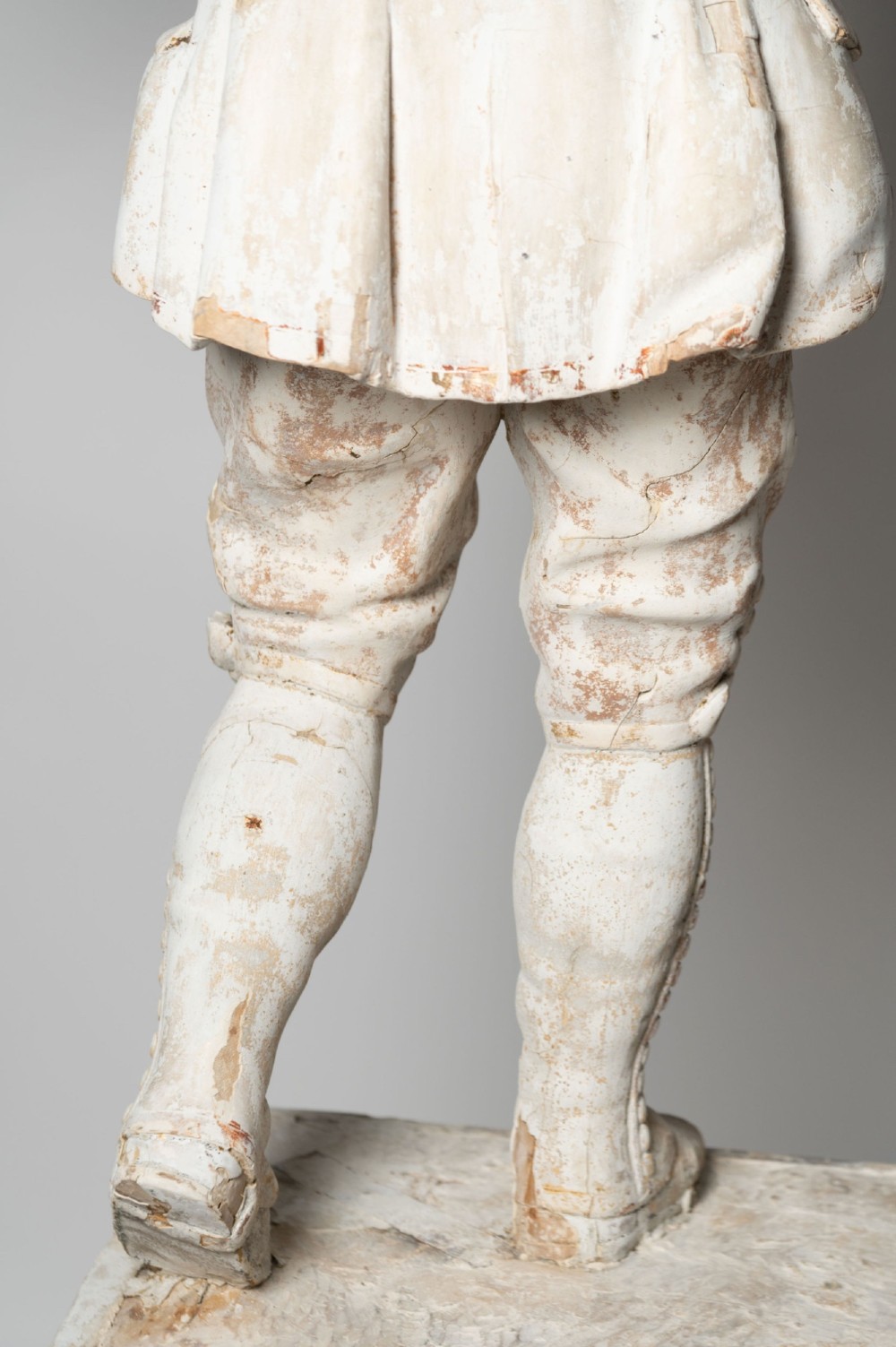 A standing antique hand-carved wooden statue of a nobleman in seventeenth-century attire with a distressed white painted finish. View VIII
