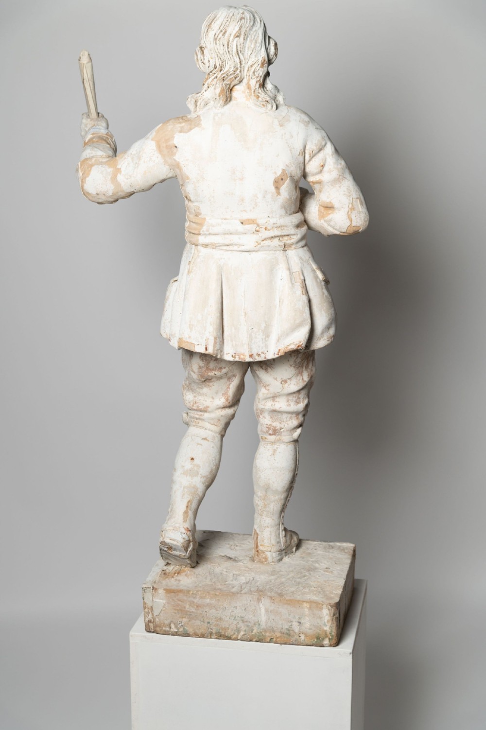 A standing antique hand-carved wooden statue of a nobleman in seventeenth-century attire with a distressed white painted finish. View IX