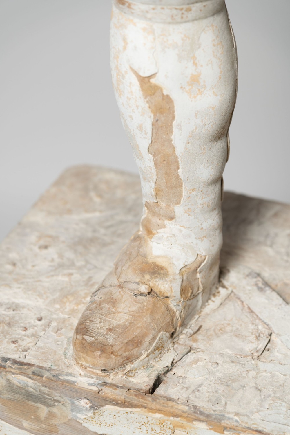 A standing antique hand-carved wooden statue of a nobleman in seventeenth-century attire with a distressed white painted finish. View X
