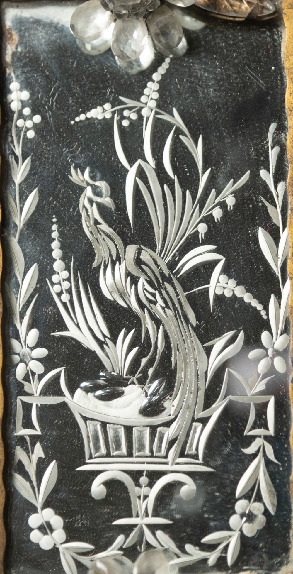 A pair of French gilt metal wall sconces featuring verre eglomise panels depicting birds, with floral crystal cresting and two scroll arms. View VIII