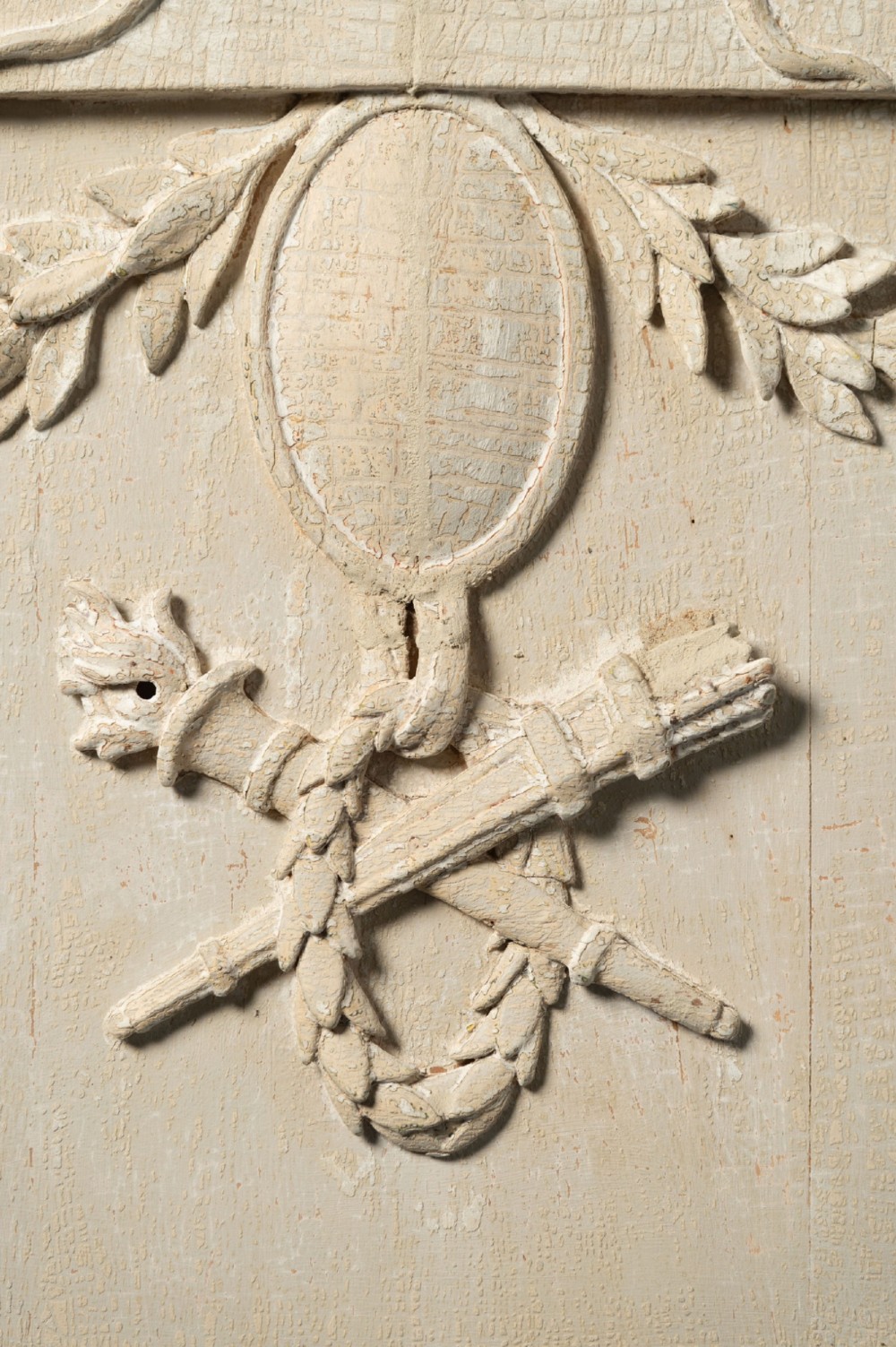 A rectangular off-white painted wood panel featuring an intricate raised relief carving of heraldic cranes, a fruit-filled urn, caduceus serpents, and laurel swags within a moulded frame. View IV