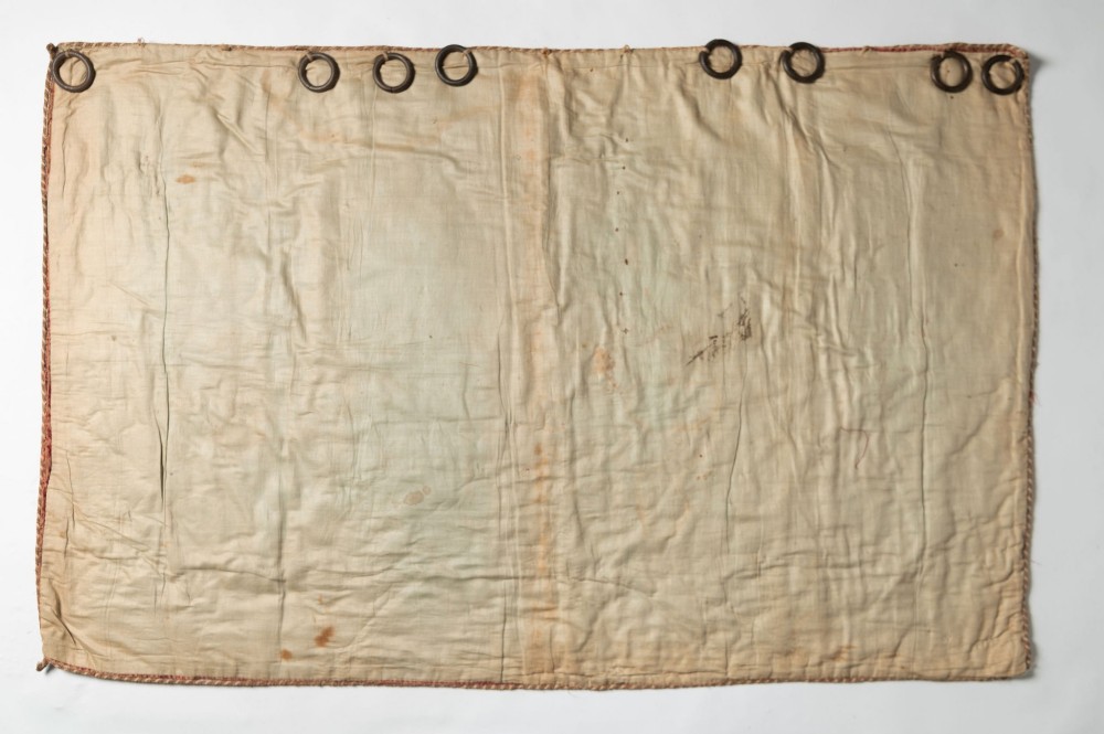A rectangular 18th-century hand-embroidered textile featuring a central diamond medallion with floral arabesques and border patterns in shades of muted pink, sage green, and cream. View X