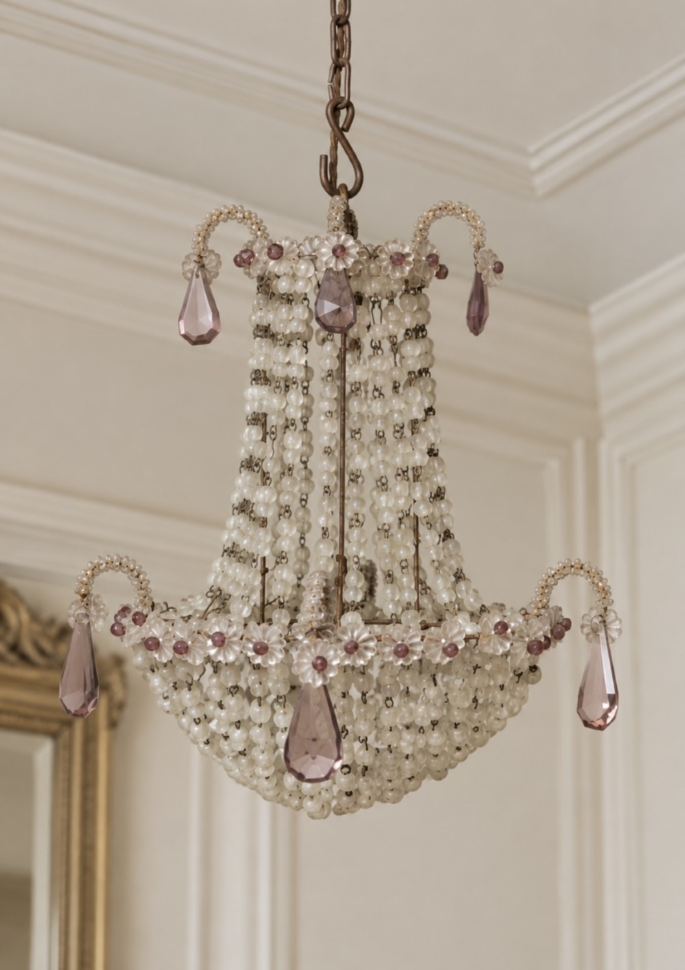 An Italian beaded glass chandelier featuring strands of clear glass beads forming a basket shape with hanging purple glass teardrop pendants.