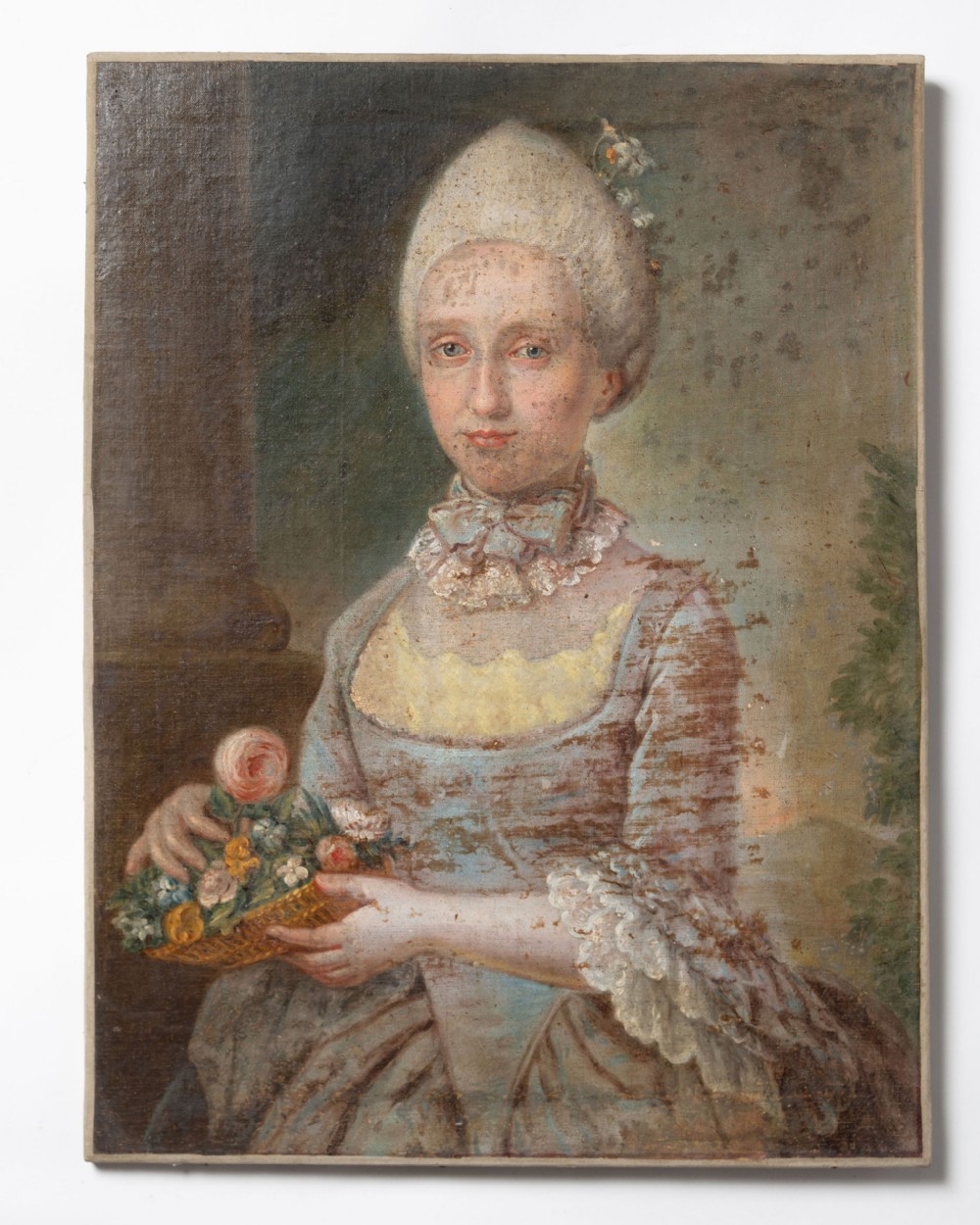 An 18th-century oil on canvas portrait depicting a noblewoman with high powdered hair and a blue dress holding a basket of flowers.