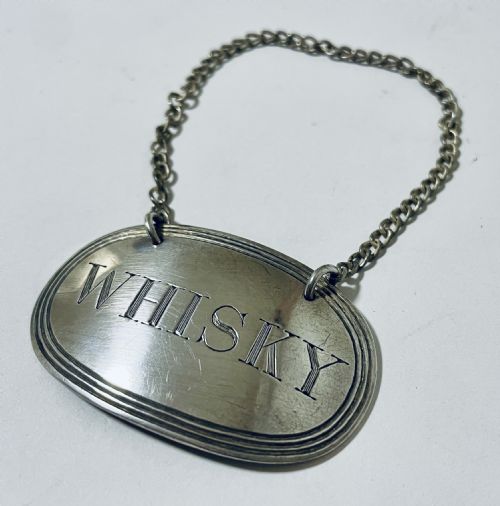 Antique Silver Whisky Label
