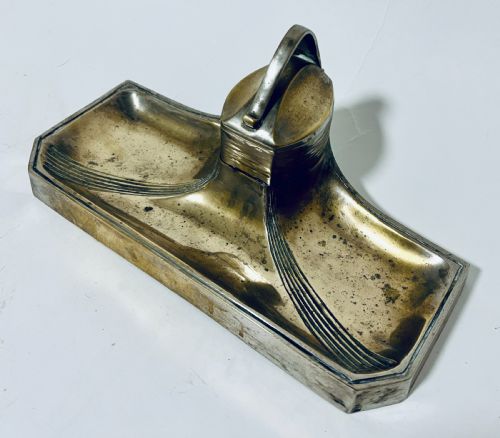 fig 1. An antique Art Nouveau silver-plated desk stand featuring a central hinged inkwell flanked by two pen trays.