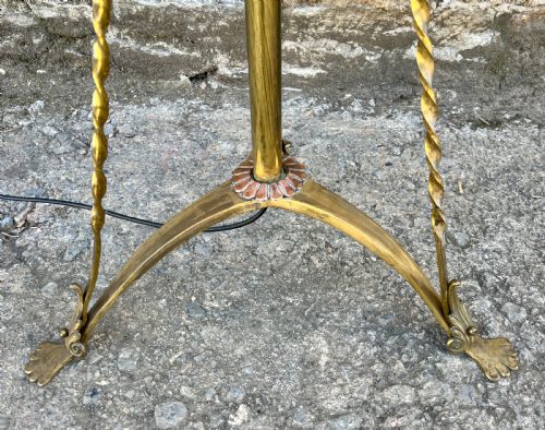 fig 1. An antique brass telescopic standard lamp featuring tripod legs with scroll details and an adjustable vertical stem.