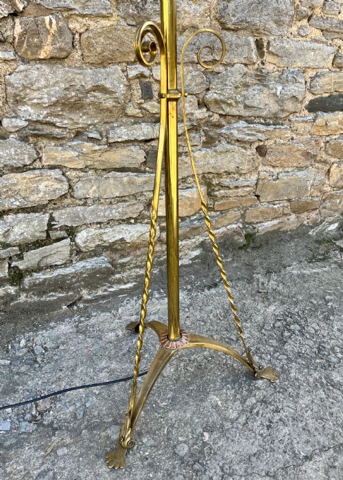 fig 2. An antique brass telescopic standard lamp featuring tripod legs with scroll details and an adjustable vertical stem.