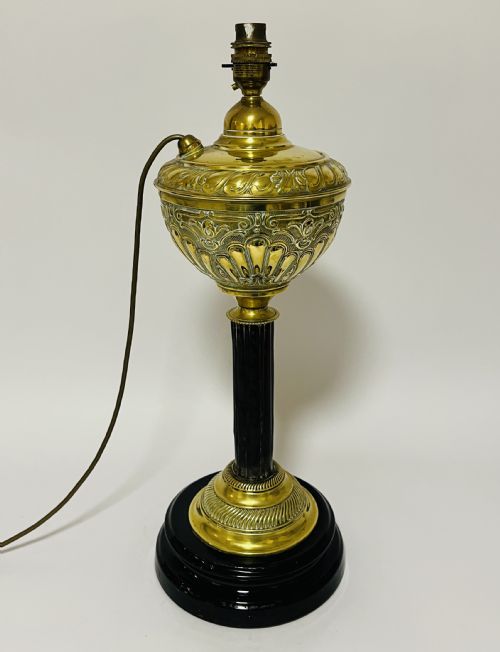 fig 1. An antique Victorian embossed brass oil lamp converted into an electric table lamp with a reeded column and black circular base.