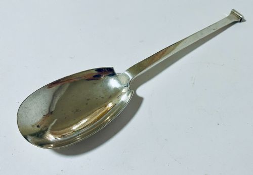 fig 1. A silver seal top spoon featuring a wide oval bowl, straight stem, and a flat seal terminal.