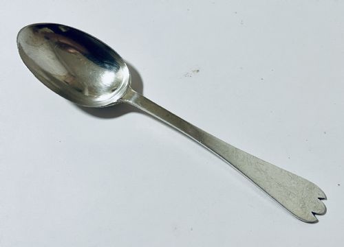 fig 2. An antique silver trefid spoon featuring a shallow oval bowl and a flat stem terminating in a distinctive notched three-pointed shape.