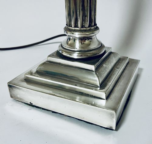 fig 2. A Victorian silver-plated table lamp designed as a fluted Corinthian column with a stepped square base.