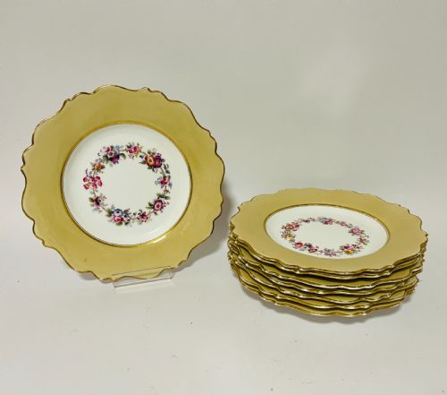 fig 1. A nineteenth-century John Ridgway porcelain dessert service featuring buff-coloured borders, gilded scrollwork, reticulated handles, and hand-painted central floral garlands.