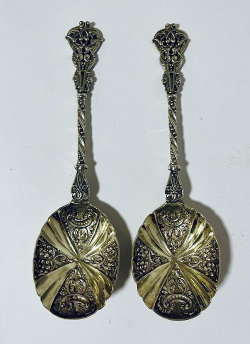 fig 1. A pair of Victorian silver-gilt serving spoons featuring fluted embossed bowls with scroll patterns and twisted handles.