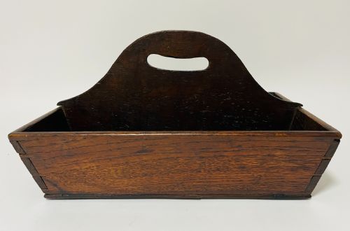 fig 1. A dark brown Georgian oak cutlery tray featuring two compartments separated by a central shaped divider with a cut-out handle.
