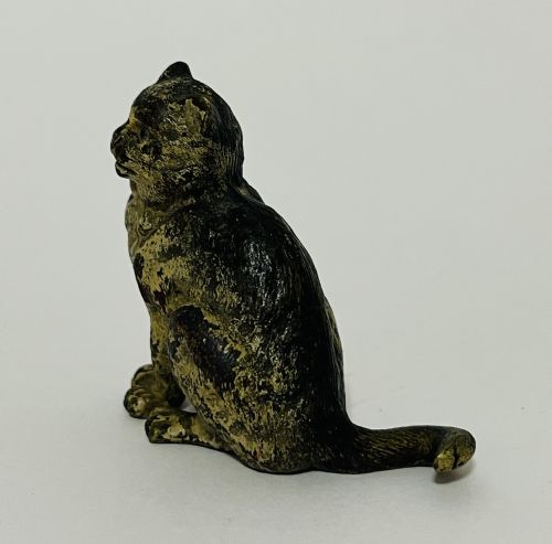 fig 1. A small Austrian cold-painted bronze figurine depicting a seated cat with textured surface detail.
